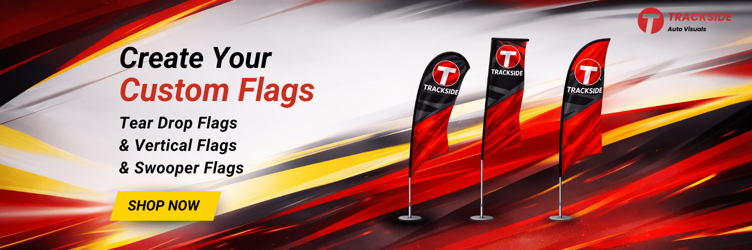 Custom flags including tear drop, vertical, and swooper flags by Trackside Auto Visuals, featuring bold red and black design, promoting car dealership supplies.