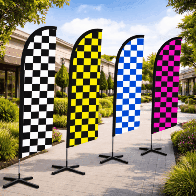 Checkered swooper flags in black, yellow, blue, and pink, displayed outdoors on stands, suitable for automotive advertising and promotions.